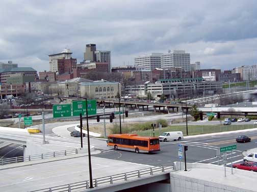 Knoxville Area Transit Bus with skyline of Knoxville and Old City in the background.