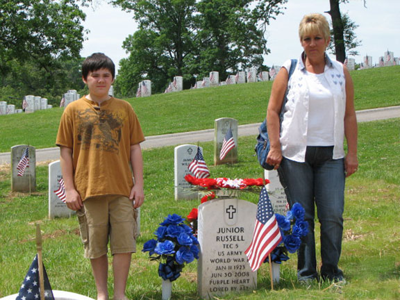 Picture of grandson and daughter in law visit a grave site of military veteran located at the Tennessee Veterans' Cemetery